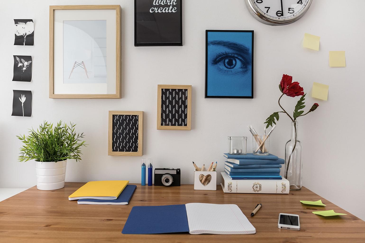 Open notebook on the desk in student's dorm room decorated with easy DIY projects.