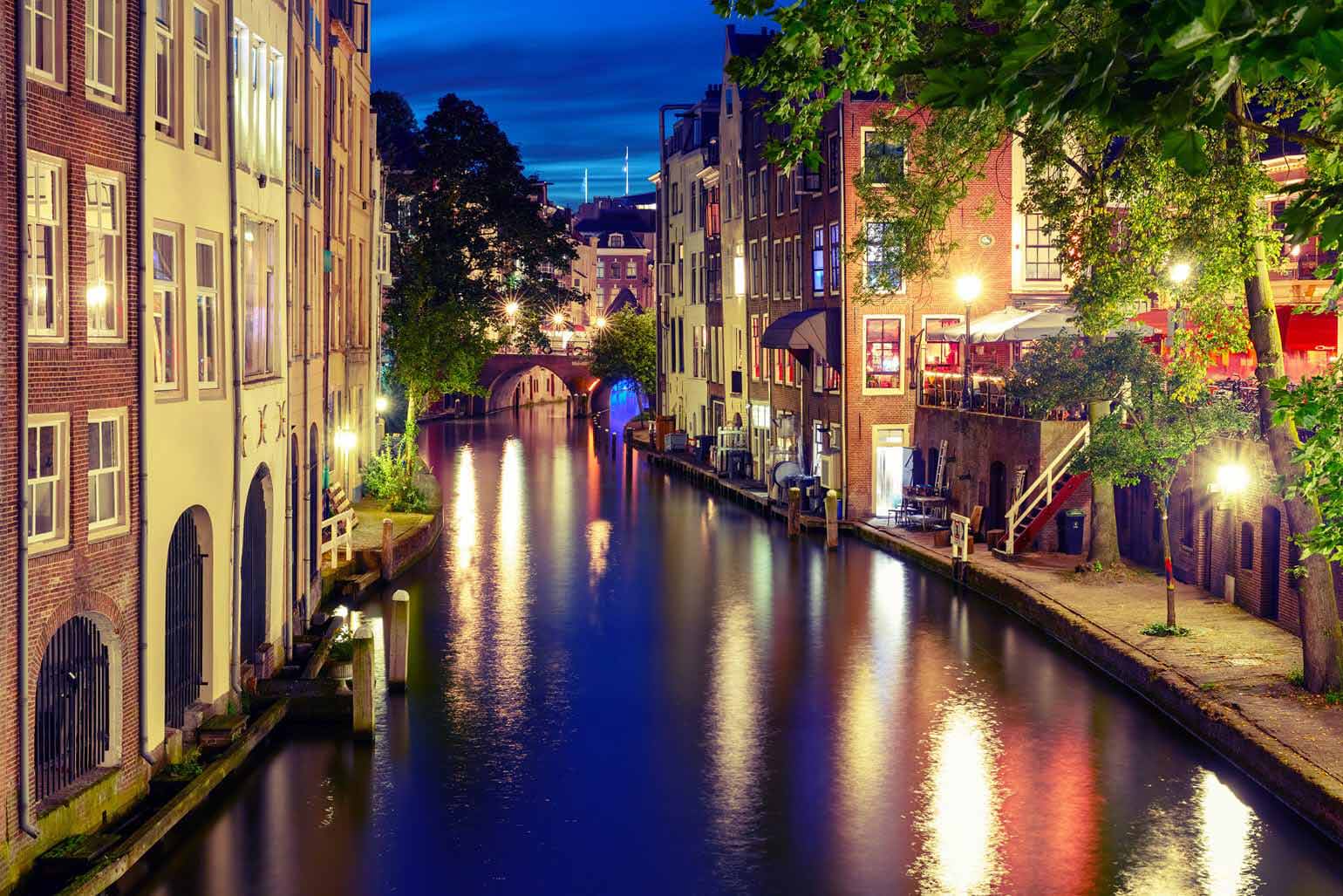 Canal Oudegracht in the night colorful illuminations in the blue hour, Utrecht, Netherlands.