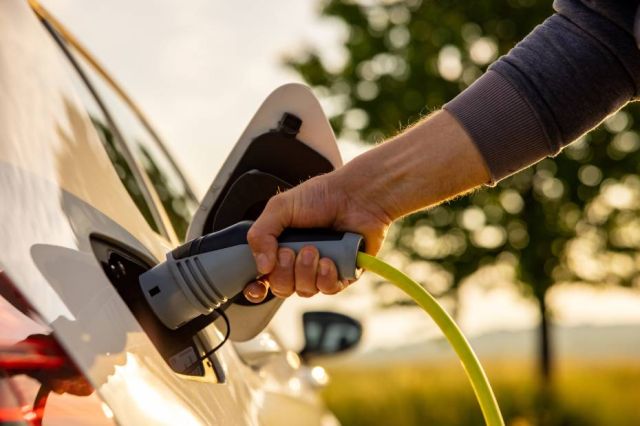 Person filling up gas in a car.