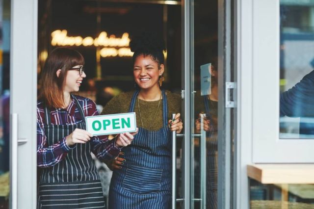 2 store owners opening their store