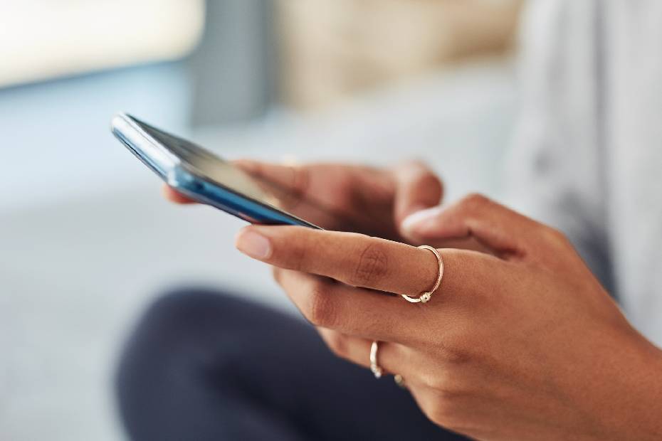 Female hands holding a mobile phone.