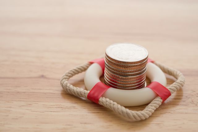 Miniature life saving ring with coins stacked inside