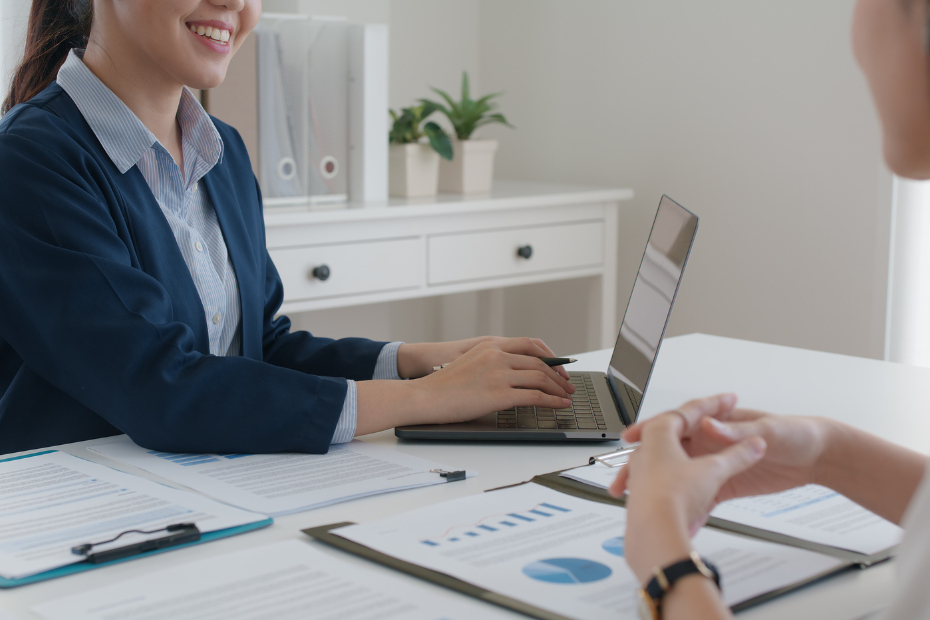 Female Asian banker speaking with a female client