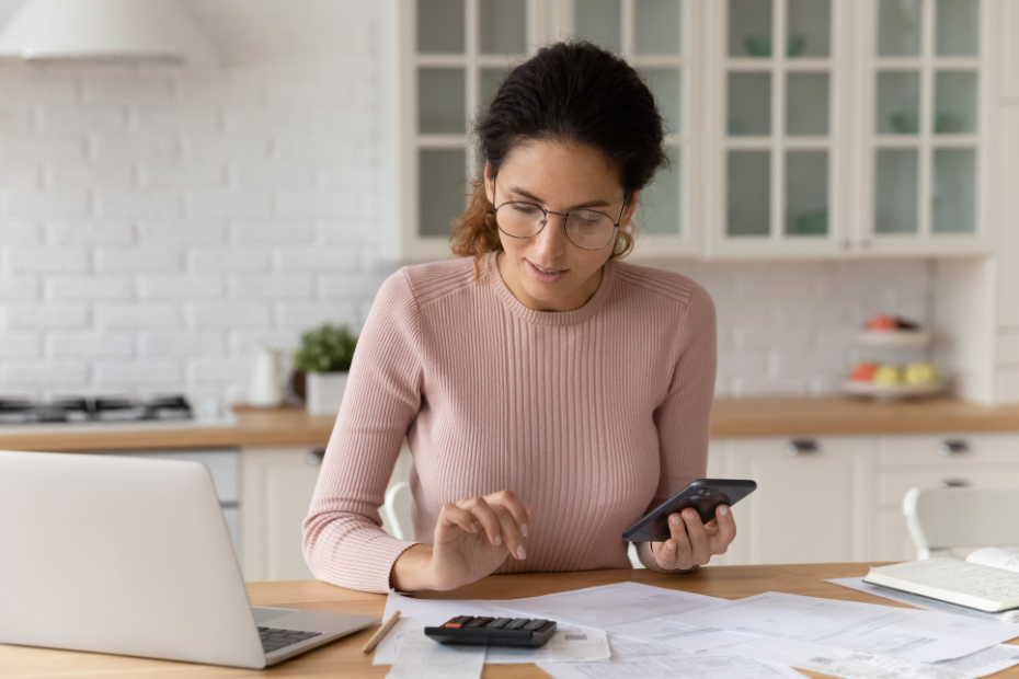 Confident woman in glasses counting bills, calculating budget at home