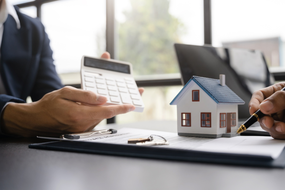 Realtor and client looking at numbers on a calculator