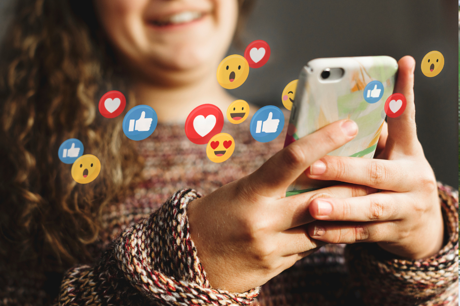 A teen using a smartphone with social media icons and emoticons floating in the air